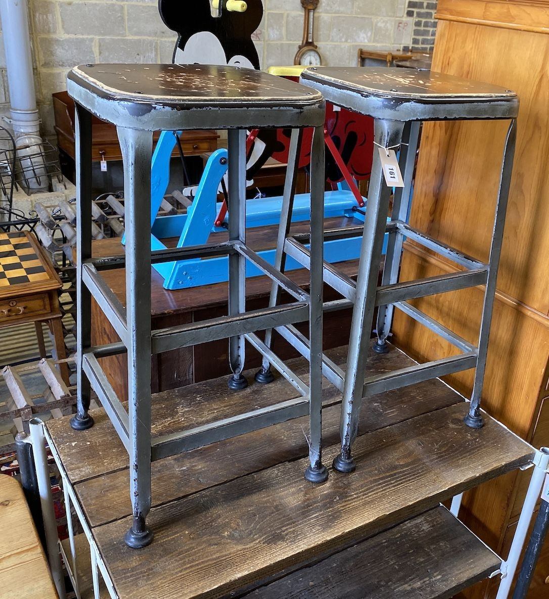 A pair of industrial style metal stools, height 74cm
